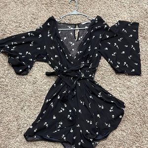 Black romper with flowers. Super cute and flattering to all body sizes!